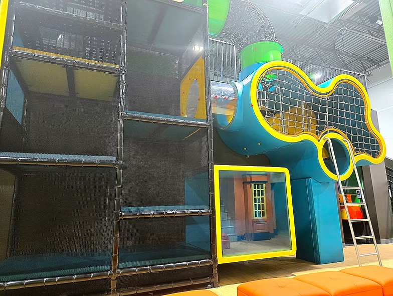 Indoor play structure with climbing and netted play areas at Funrise Indoor Playground