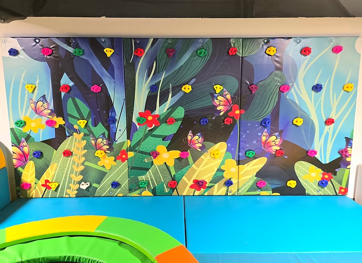 Colorful climbing wall and soft play area for young children at Funrise Indoor Playground