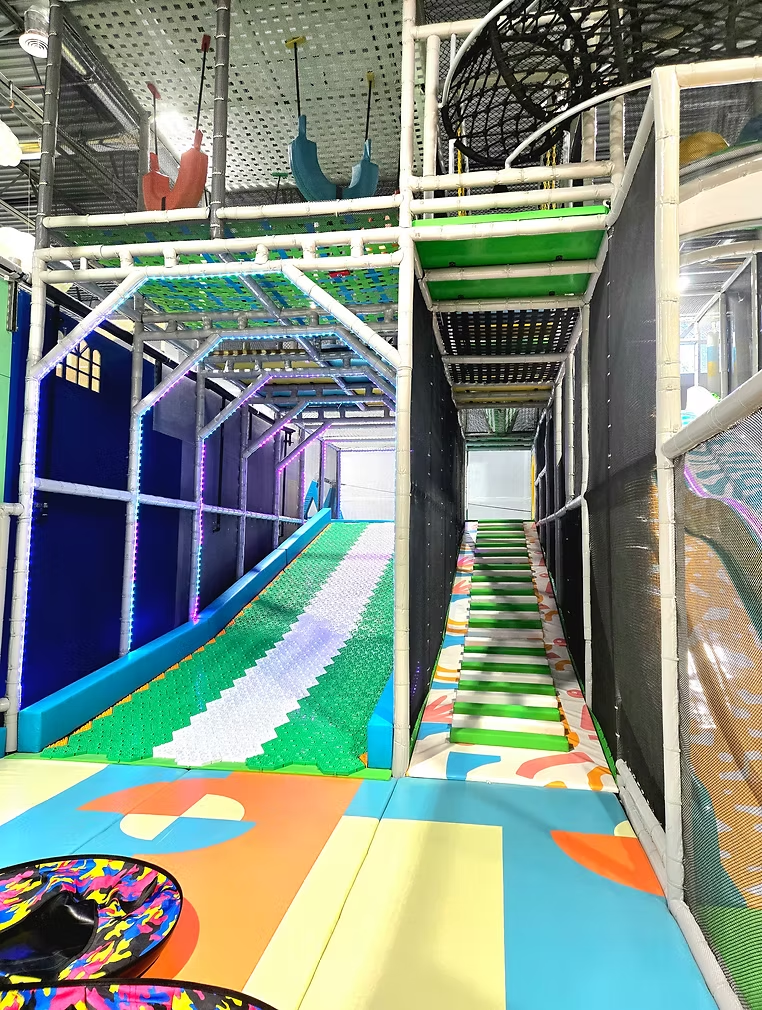 Funrise play structure with slide, stairs, and netted climbing area
